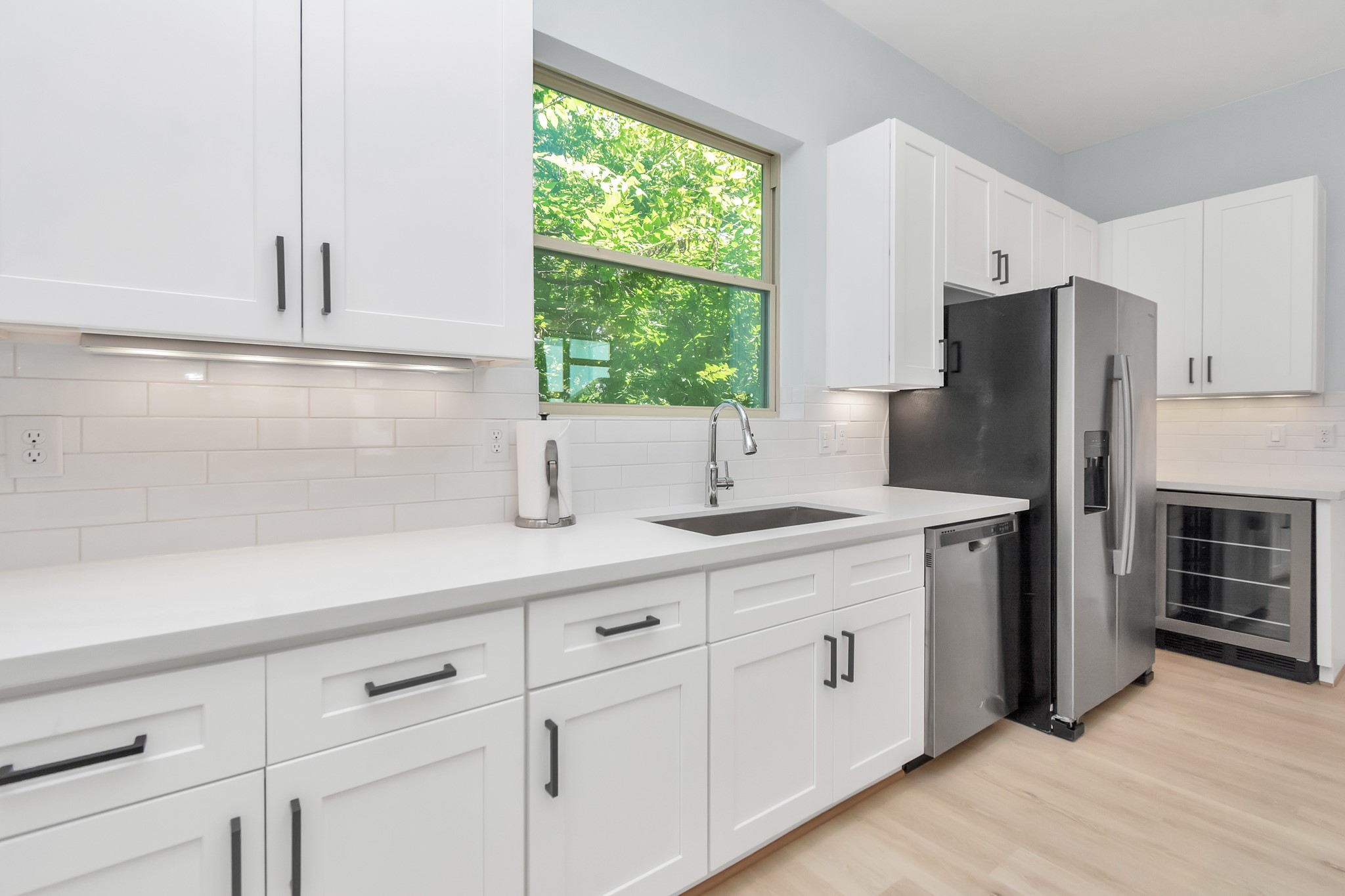 3310 Pease Street, Unit B Houston, TX 77003 - Photo 19 of 50 a kitchen with stainless steel appliances white cabinets and a window