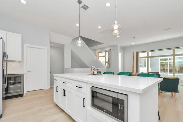 a open kitchen with stainless steel appliances granite countertop a stove a sink and a refrigerator