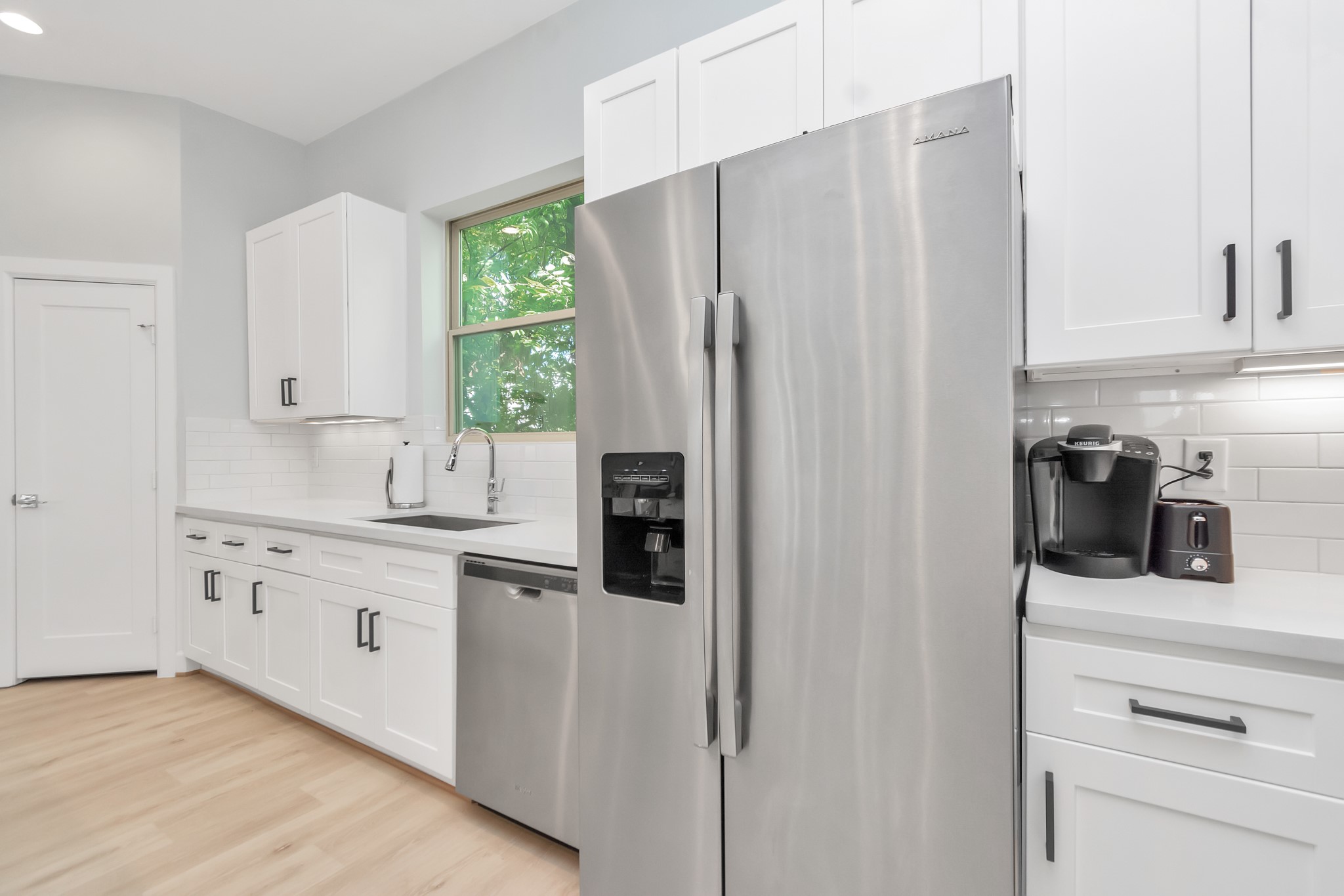 3310 Pease Street, Unit B Houston, TX 77003 - Photo 21 of 50 a kitchen with stainless steel appliances a refrigerator sink and cabinets