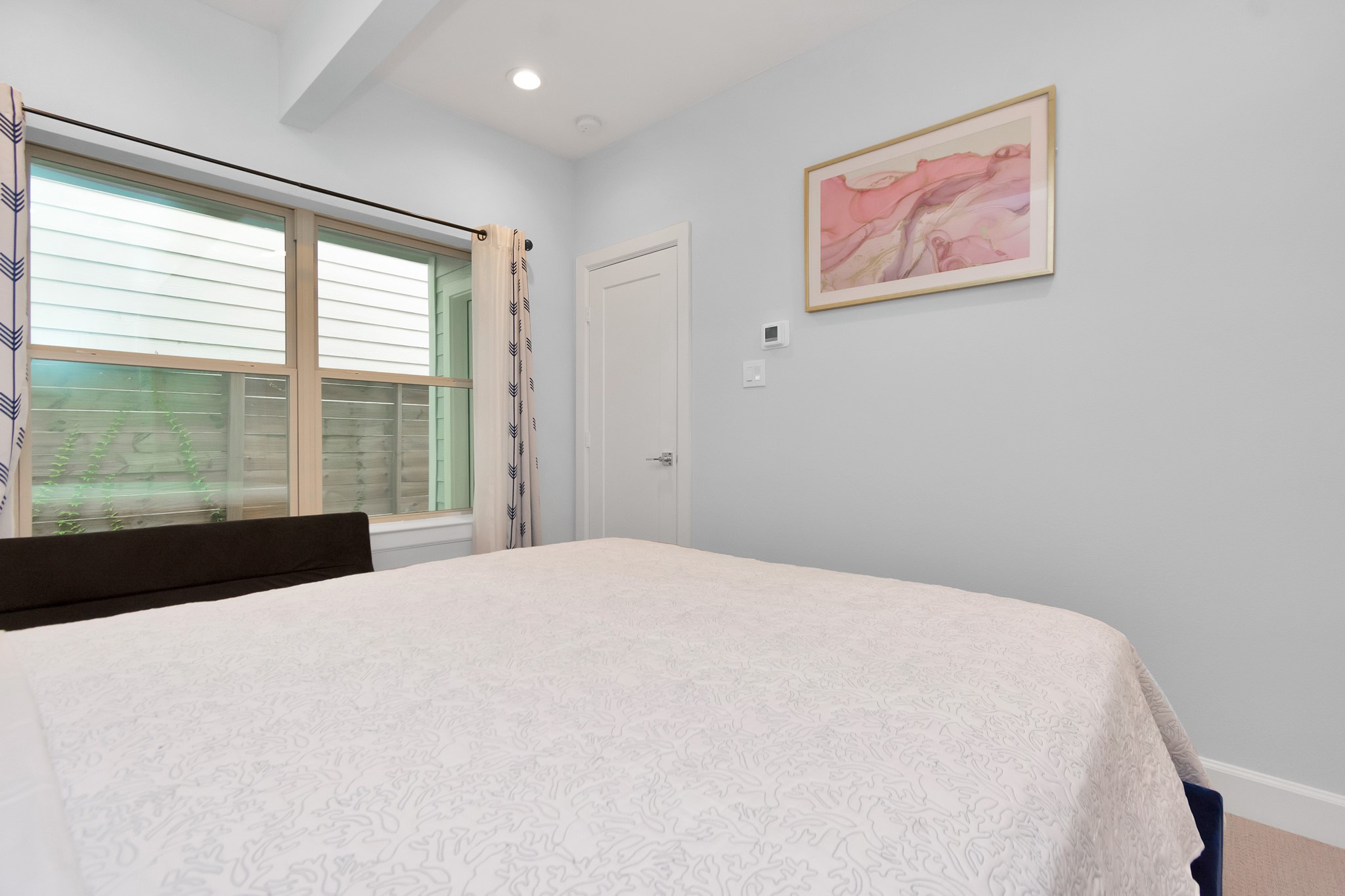 3310 Pease Street, Unit B Houston, TX 77003 - Photo 8 of 50 a large bed sitting in a bedroom next to a window