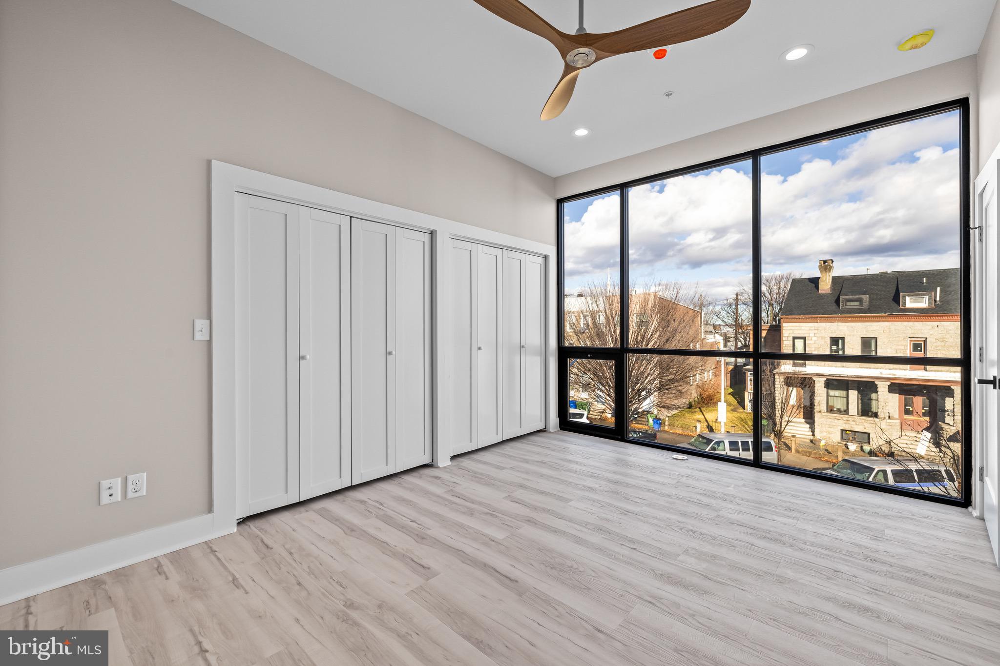 400 South Conkling Street, Unit 4 Baltimore, MD 21224 - Photo 11 of 18 a view of an empty room with wooden floor and a window