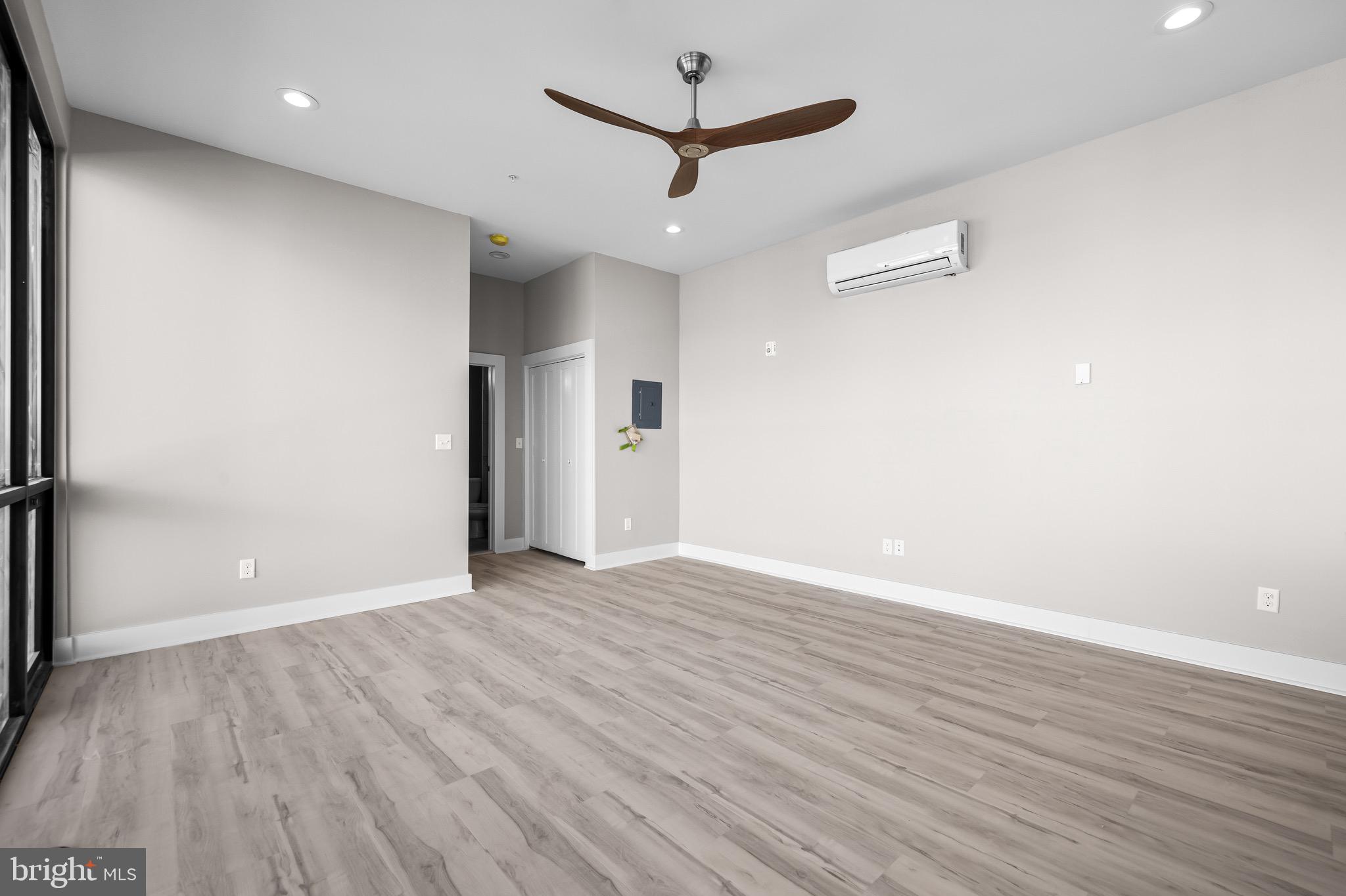 400 South Conkling Street, Unit 4 Baltimore, MD 21224 - Photo 7 of 18 an empty room with wooden floor and a ceiling fan