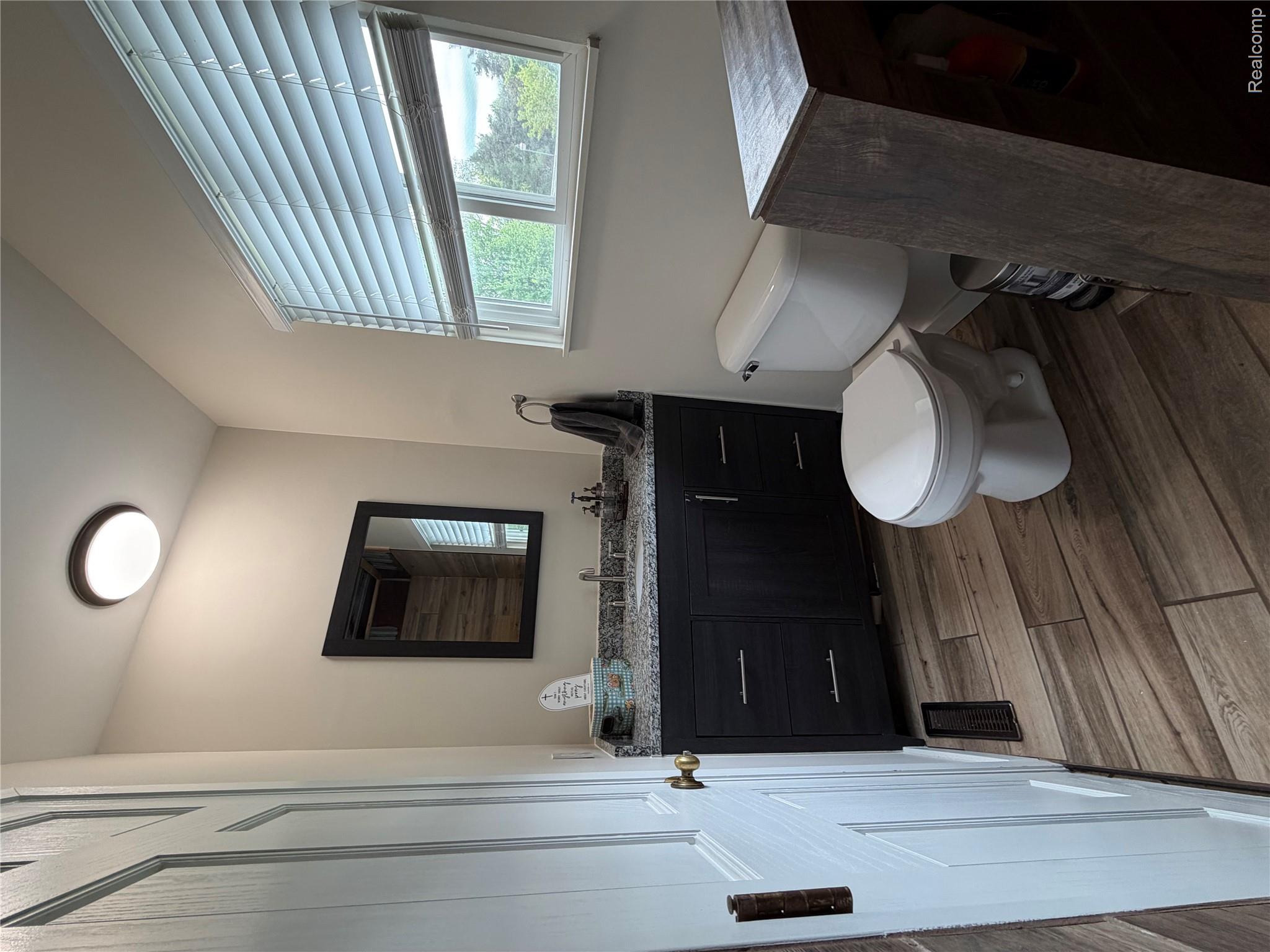 2712 North Branch Road North Branch, MI 48461 - Photo 19 of 37 Bathroom with vanity and dark wood-style floors
