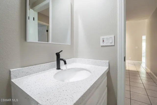 a bathroom with a sink vanity and mirror