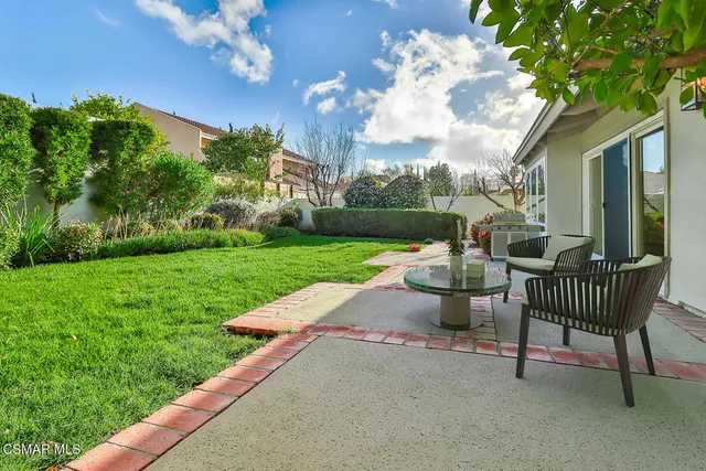 a view of a patio with a table & chairs