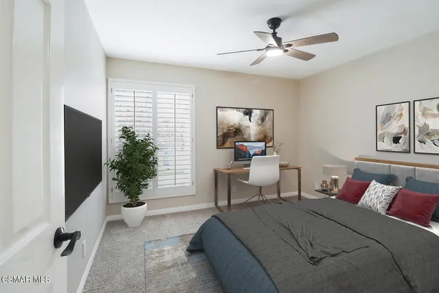 a bedroom with a bed and a potted plant