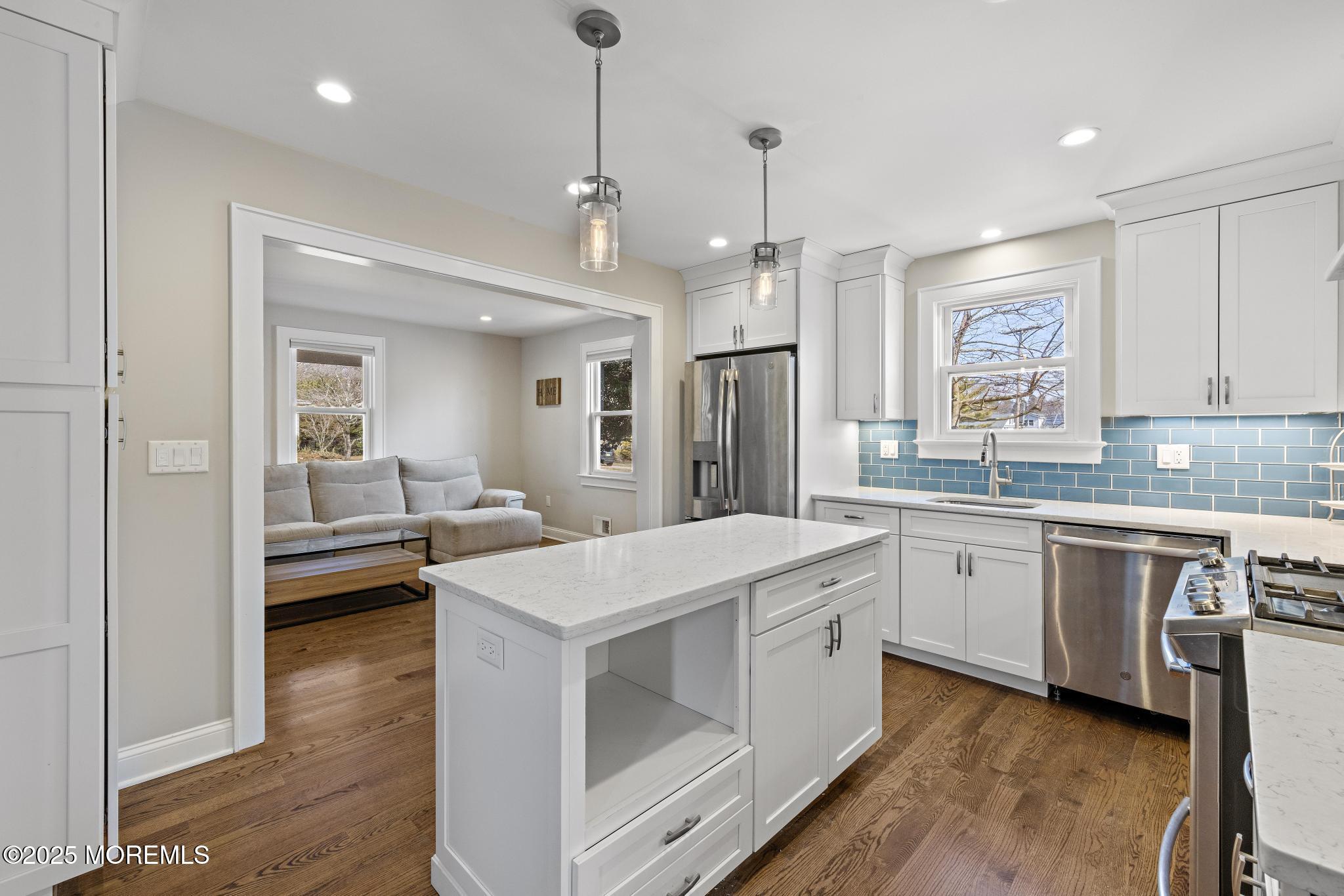 218 Cooper Road Red Bank, NJ 07701 - Photo 14 of 43 a kitchen with a sink stove and wooden floor