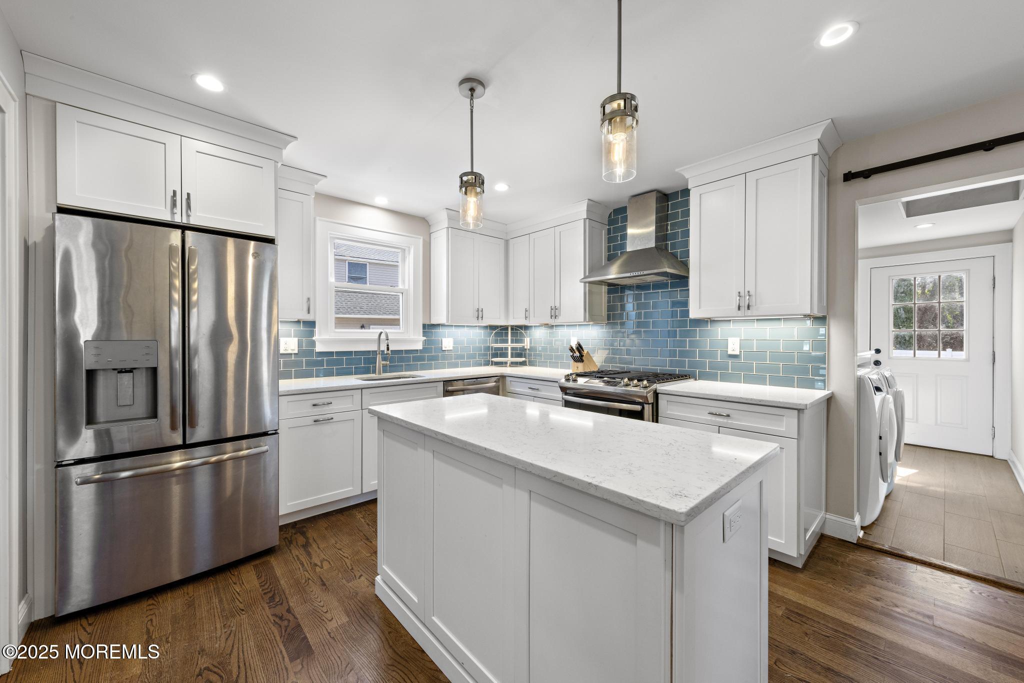 218 Cooper Road Red Bank, NJ 07701 - Photo 15 of 43 a kitchen with stainless steel appliances granite countertop a refrigerator a sink dishwasher a stove and white cabinets with wooden floor