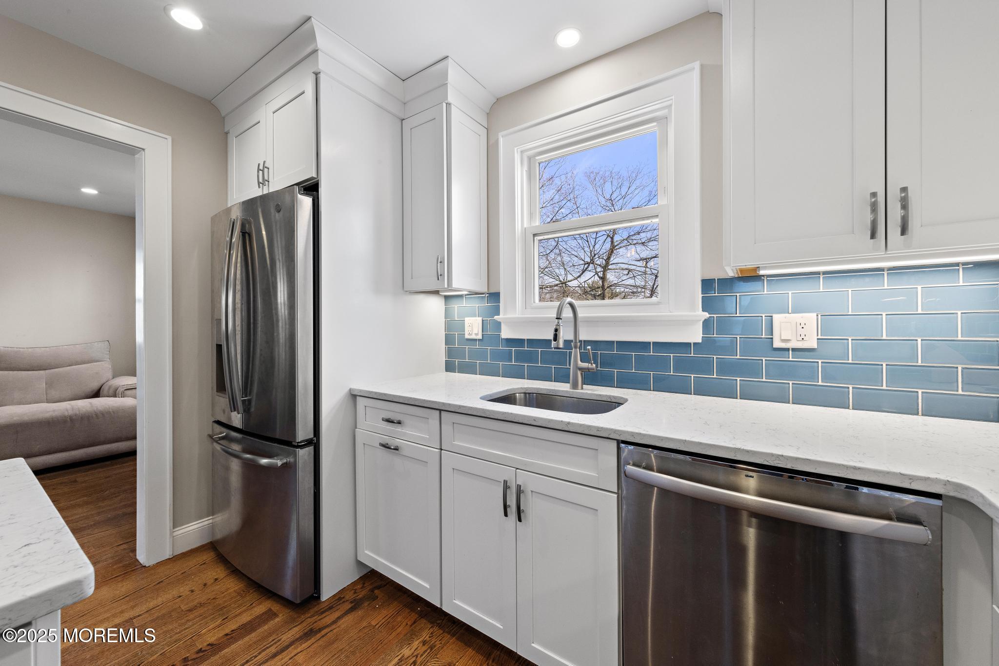 218 Cooper Road Red Bank, NJ 07701 - Photo 17 of 43 a kitchen with stainless steel appliances a refrigerator sink and cabinets