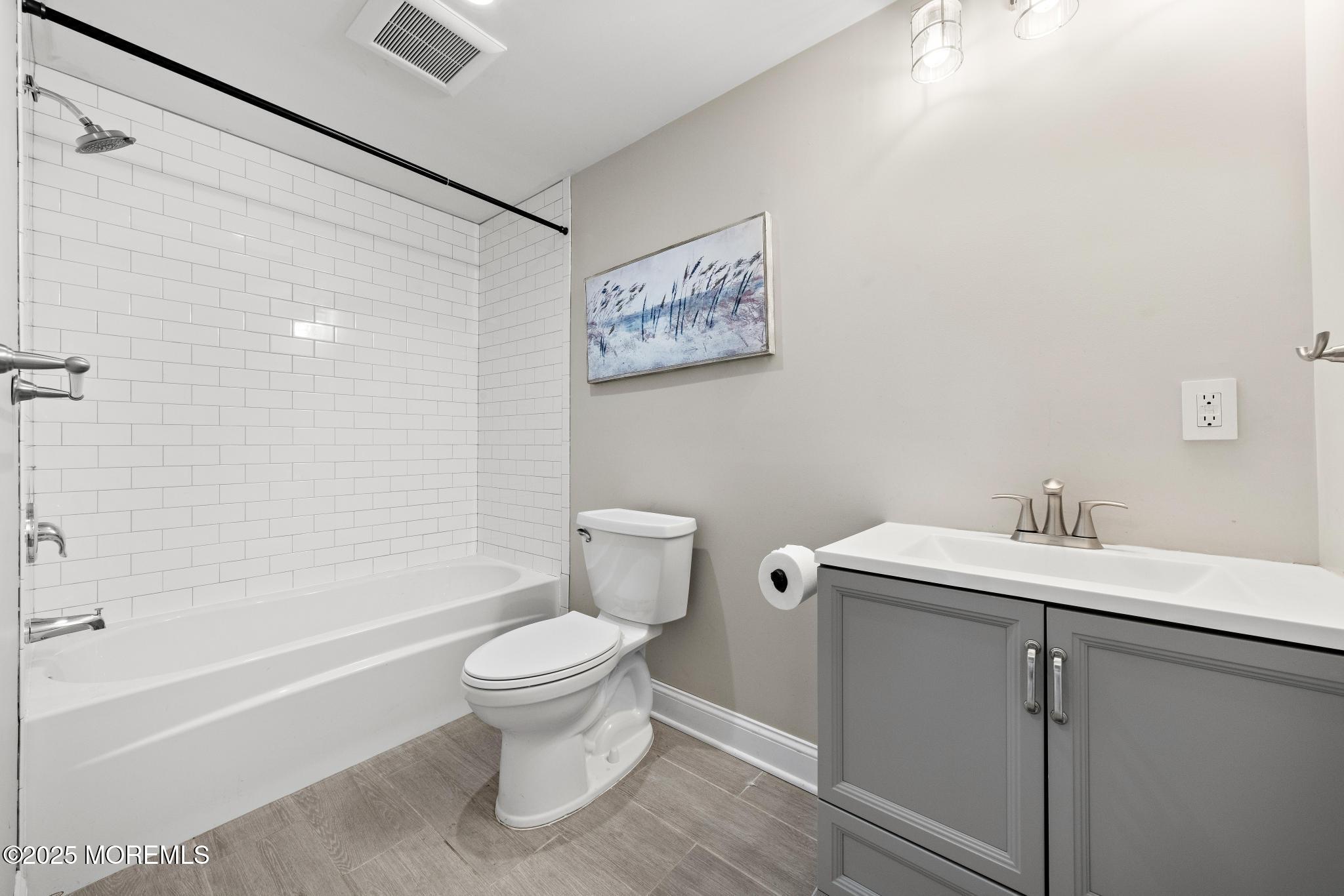 218 Cooper Road Red Bank, NJ 07701 - Photo 21 of 43 a bathroom with a sink a toilet and a bathtub