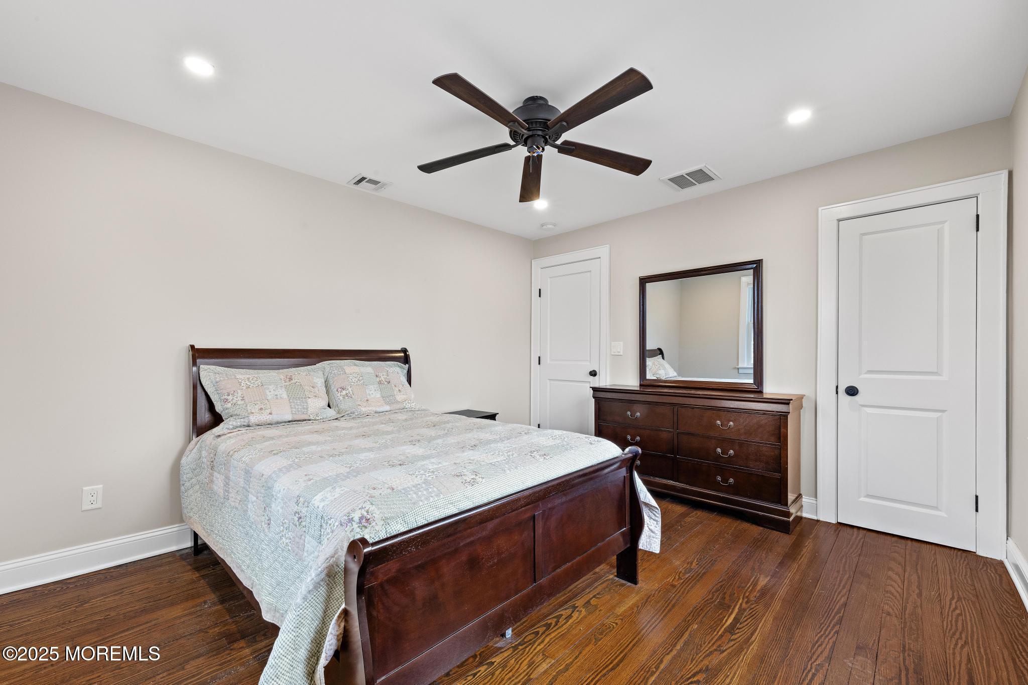 218 Cooper Road Red Bank, NJ 07701 - Photo 26 of 43 a bedroom with a bed and wooden floor