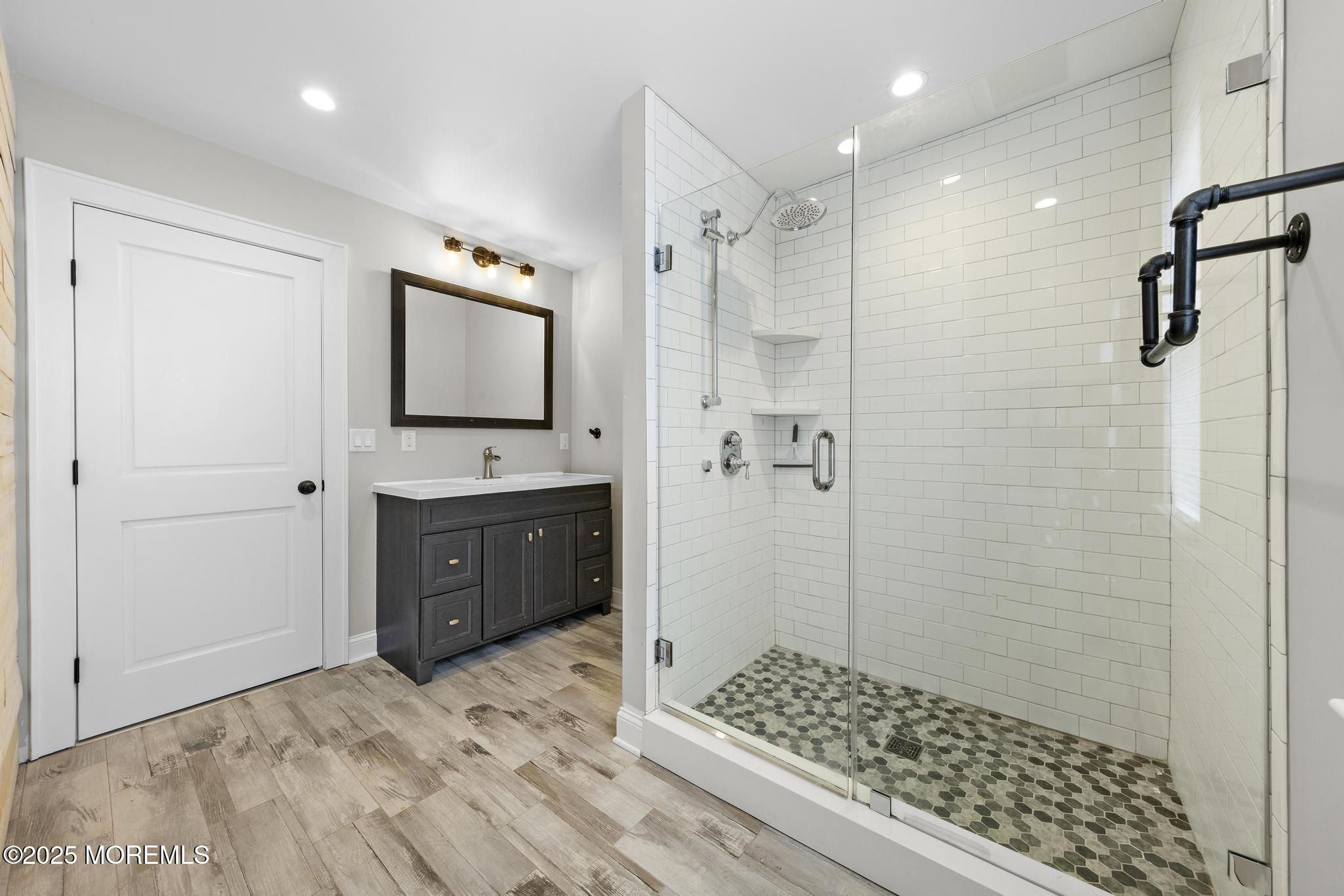 218 Cooper Road Red Bank, NJ 07701 - Photo 28 of 43 a bathroom with a shower a sink and a mirror
