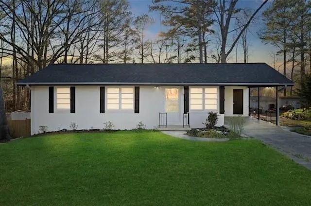 a backyard of a house with table and chairs