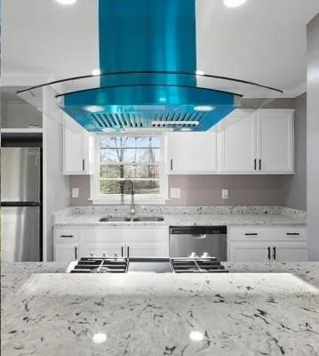 a kitchen with a refrigerator a sink and a stove