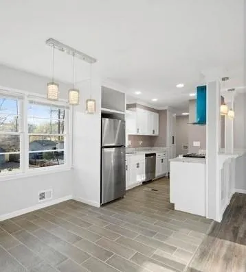 a kitchen with white cabinets and white appliances