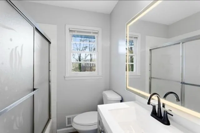 a bathroom with a sink toilet and shower