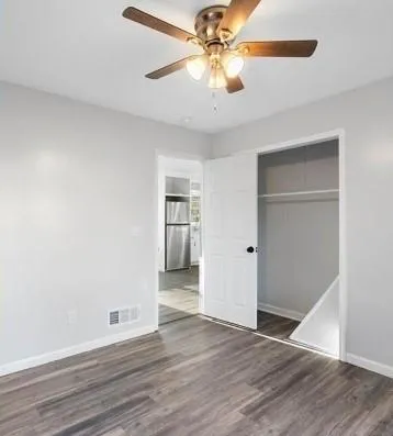 a view of an empty room with wooden floor