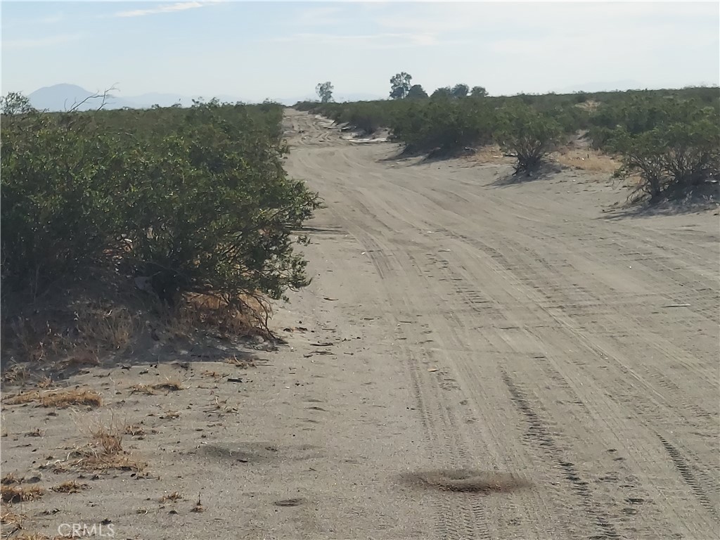 0 Bookasta Street Adelanto, CA 92301 - Photo 3 of 8 a view of a dry yard with wooden fence