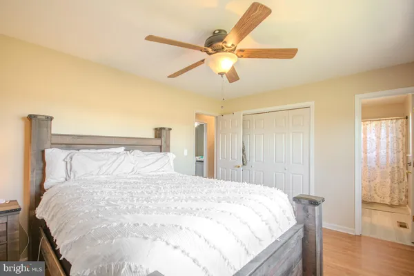 a large bed sitting in a bedroom next to a window