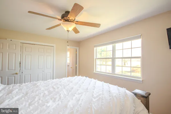 a bedroom with a large bed and a window