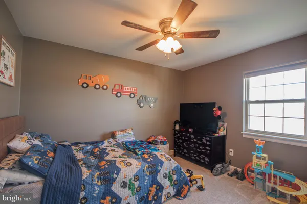 a bedroom with a bed window and a chandelier
