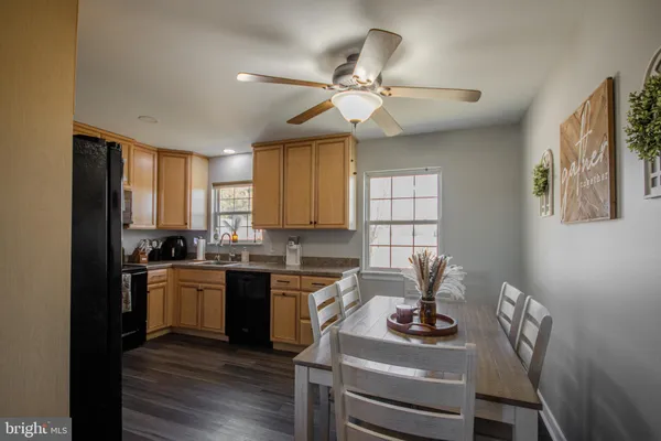 a kitchen with a stove cabinets and wooden floor