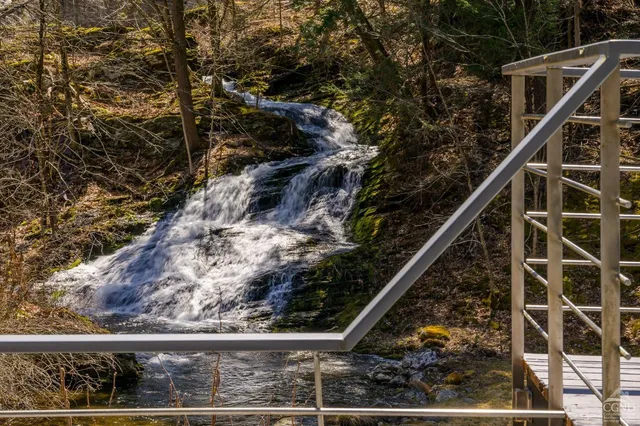 a kitchen with stainless steel appliances kitchen island granite countertop a stove a sink and a microwave