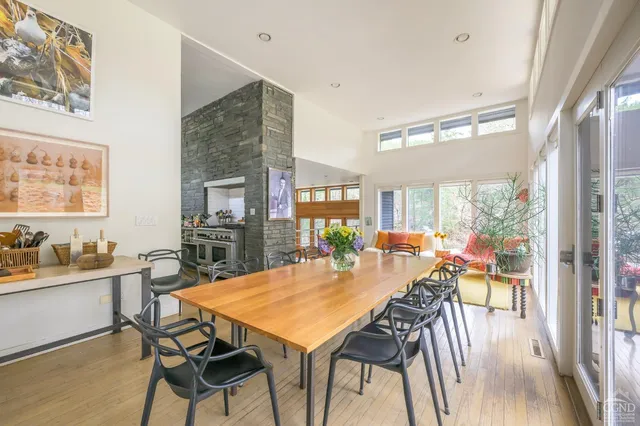 a living room with furniture and a floor to ceiling window
