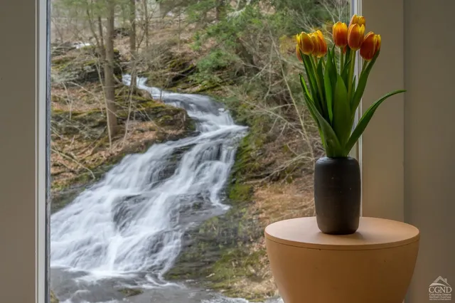 a bedroom with a bed and a large window