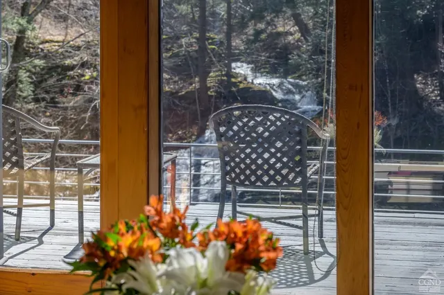 a bathroom with a tub a sink and a large window