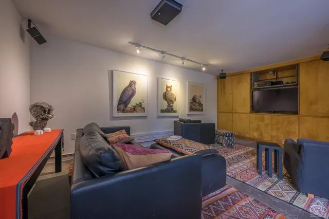 a living room with furniture and a walk in closet