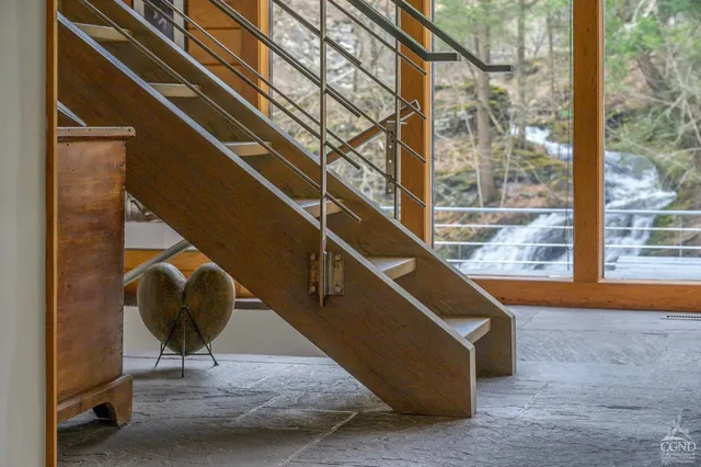 a bedroom with a bed and a couch next to a window