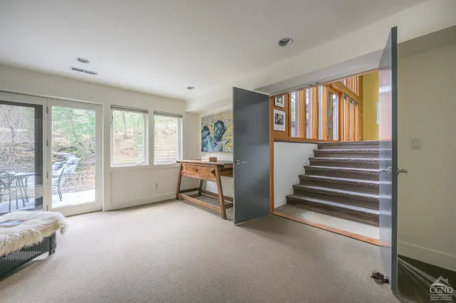 a bathroom with a granite countertop sink a toilet a mirror and shower