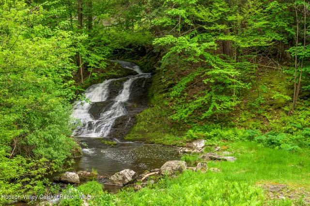 an aerial view of a house with garden space and street view