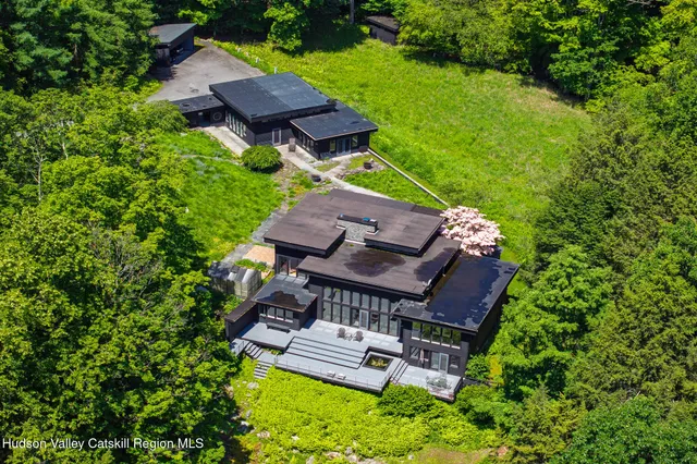 a view of a water pond with green yard