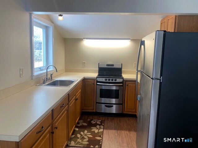 a kitchen with a sink and a refrigerator