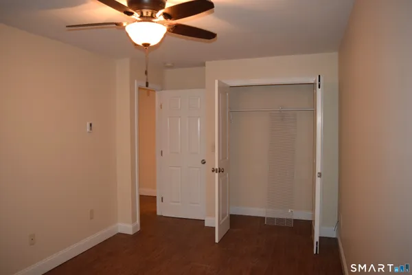 a view of a hallway with a chandelier fan