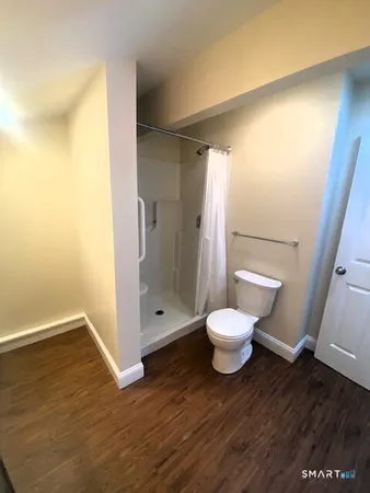 a bathroom with a toilet and a shower