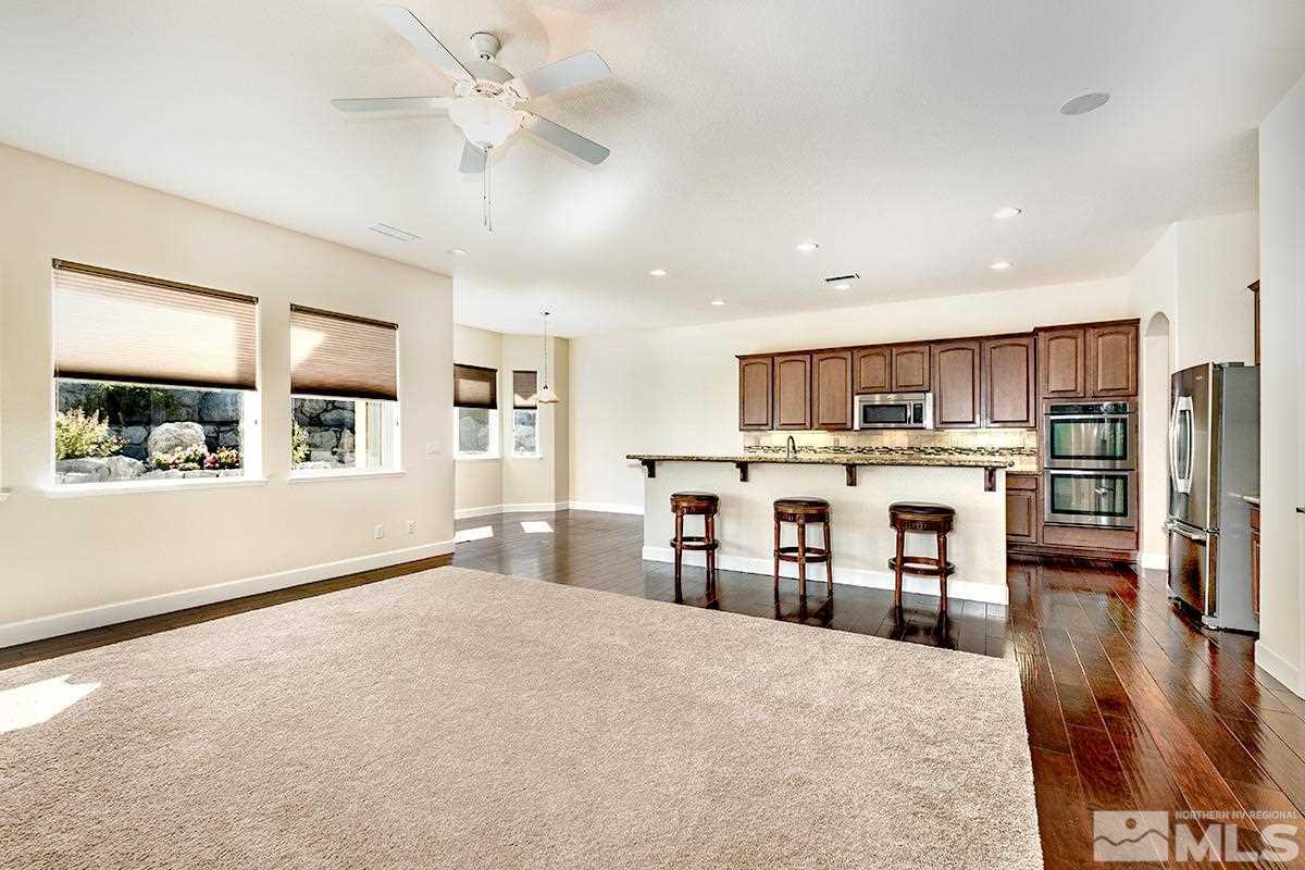 10190 Gold Mine Drive Reno, NV 89521 - Photo 11 of 25 a large kitchen with stainless steel appliances kitchen island granite countertop a refrigerator and cabinets