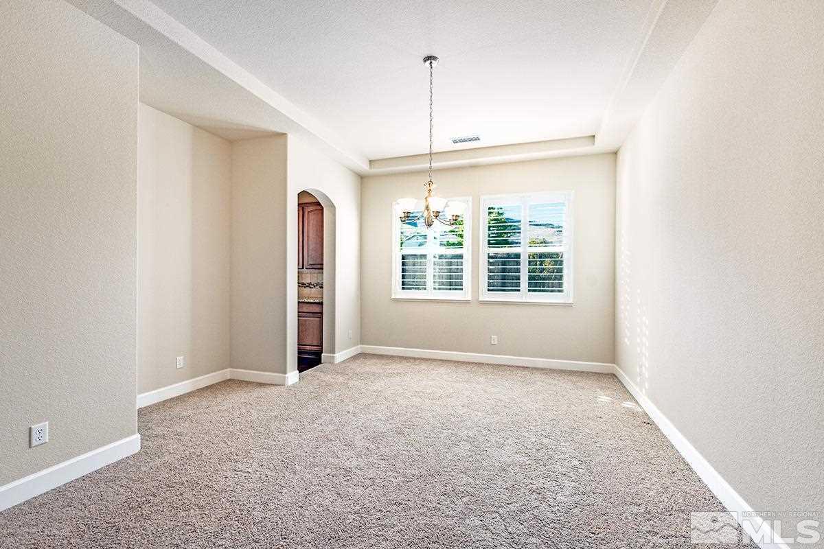 10190 Gold Mine Drive Reno, NV 89521 - Photo 8 of 25 an empty room with a window and chandelier