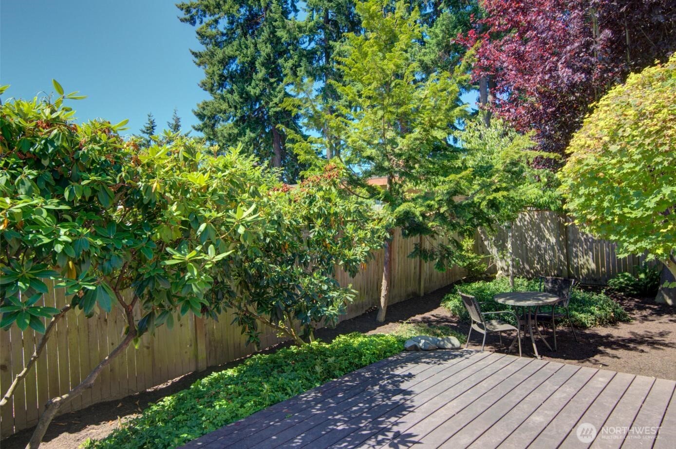 7522 221st Place Southwest Edmonds, WA 98026 - Photo 14 of 16 a view of backyard with table and chairs and potted plants