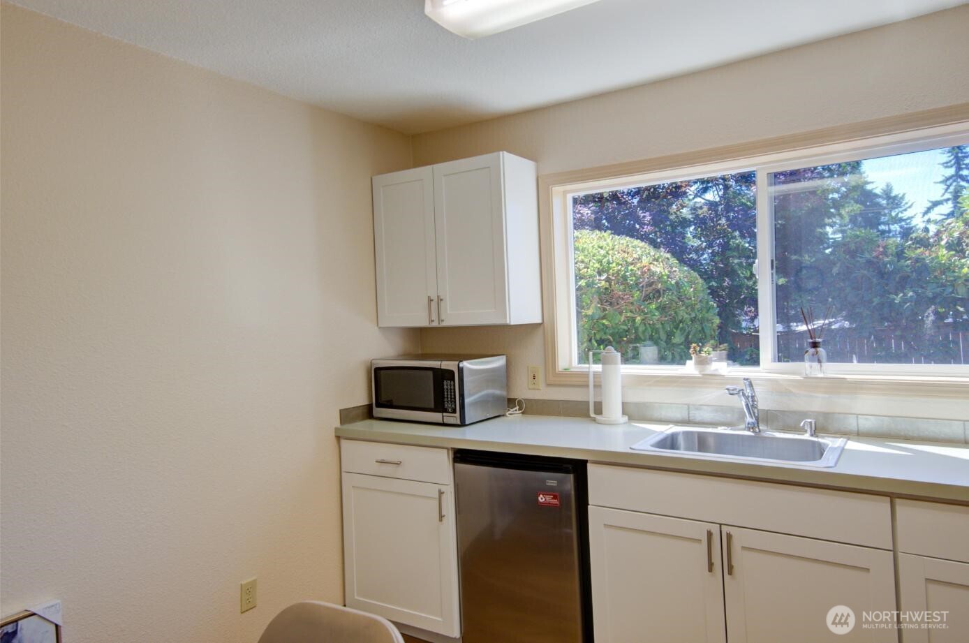 7522 221st Place Southwest Edmonds, WA 98026 - Photo 9 of 16 a kitchen with granite countertop white cabinets and a large window