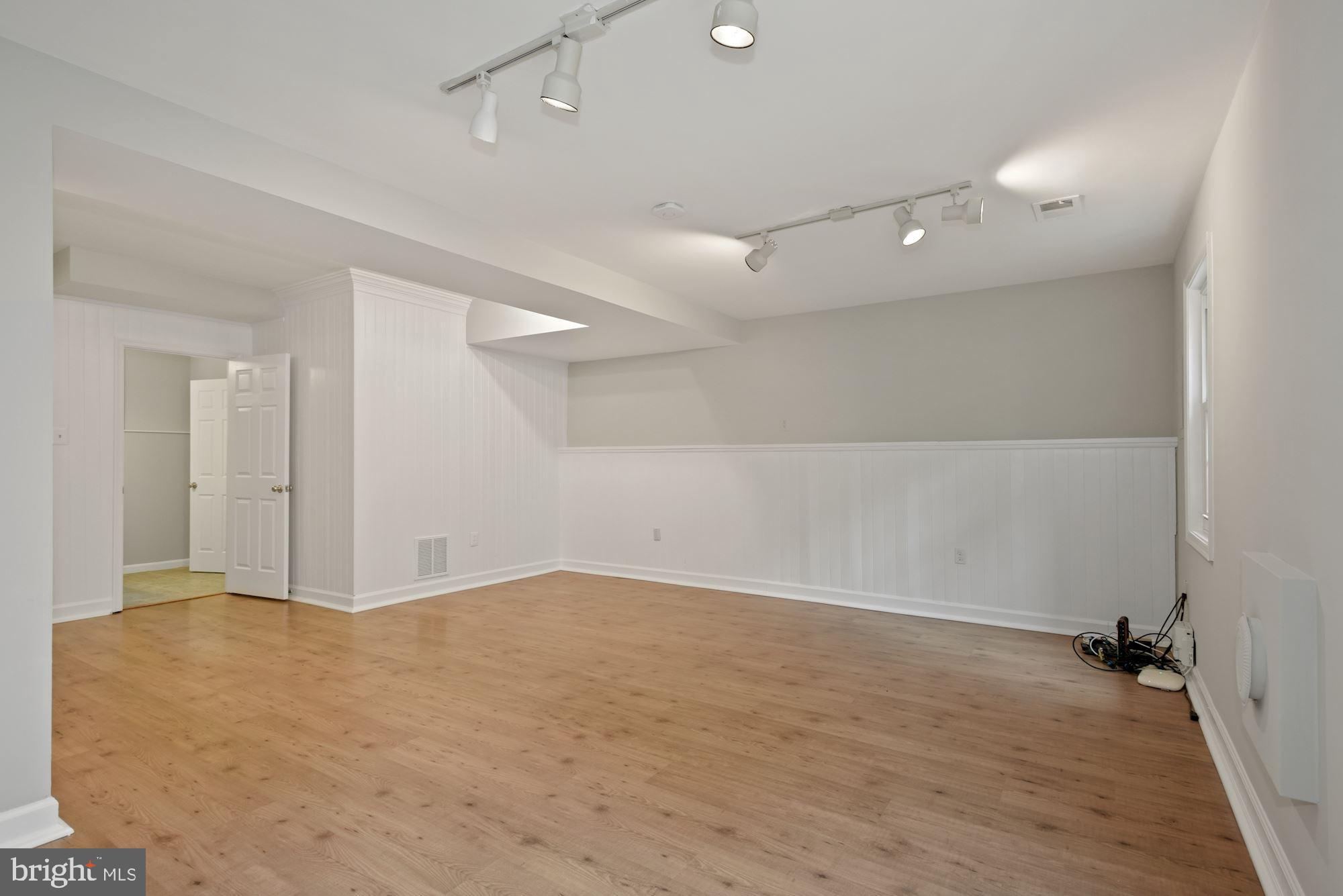 2328 Hunters Square Court Reston, VA 20191 - Photo 22 of 28 Large recreation room with wood laminate floors