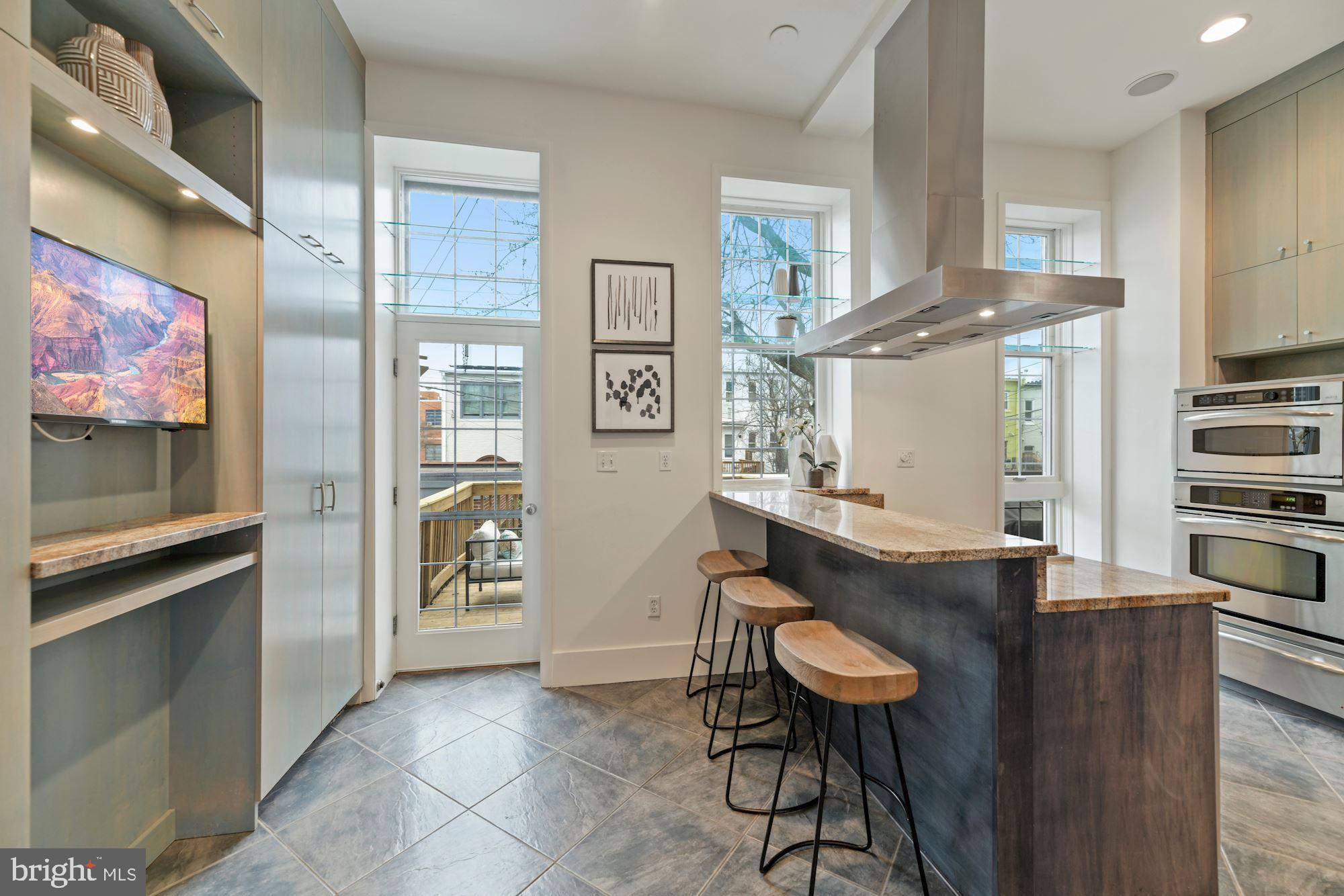 1313 Riggs Street Northwest Washington, DC 20009 - Photo 7 of 35 Main Level Kitchen with Breakfast Bar Seating