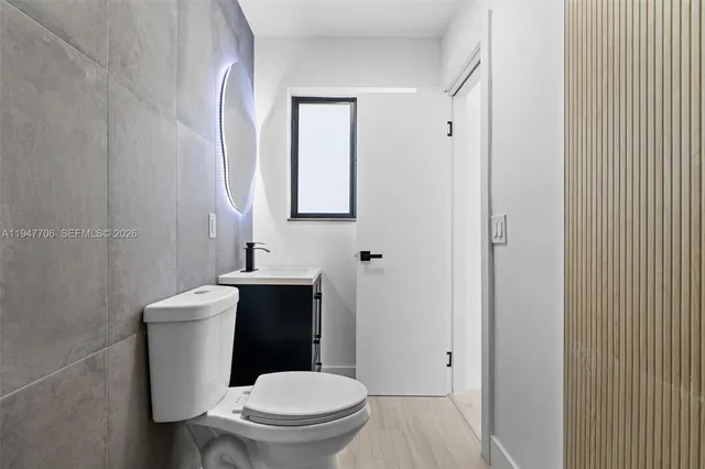 a view of a room with wooden floor and window