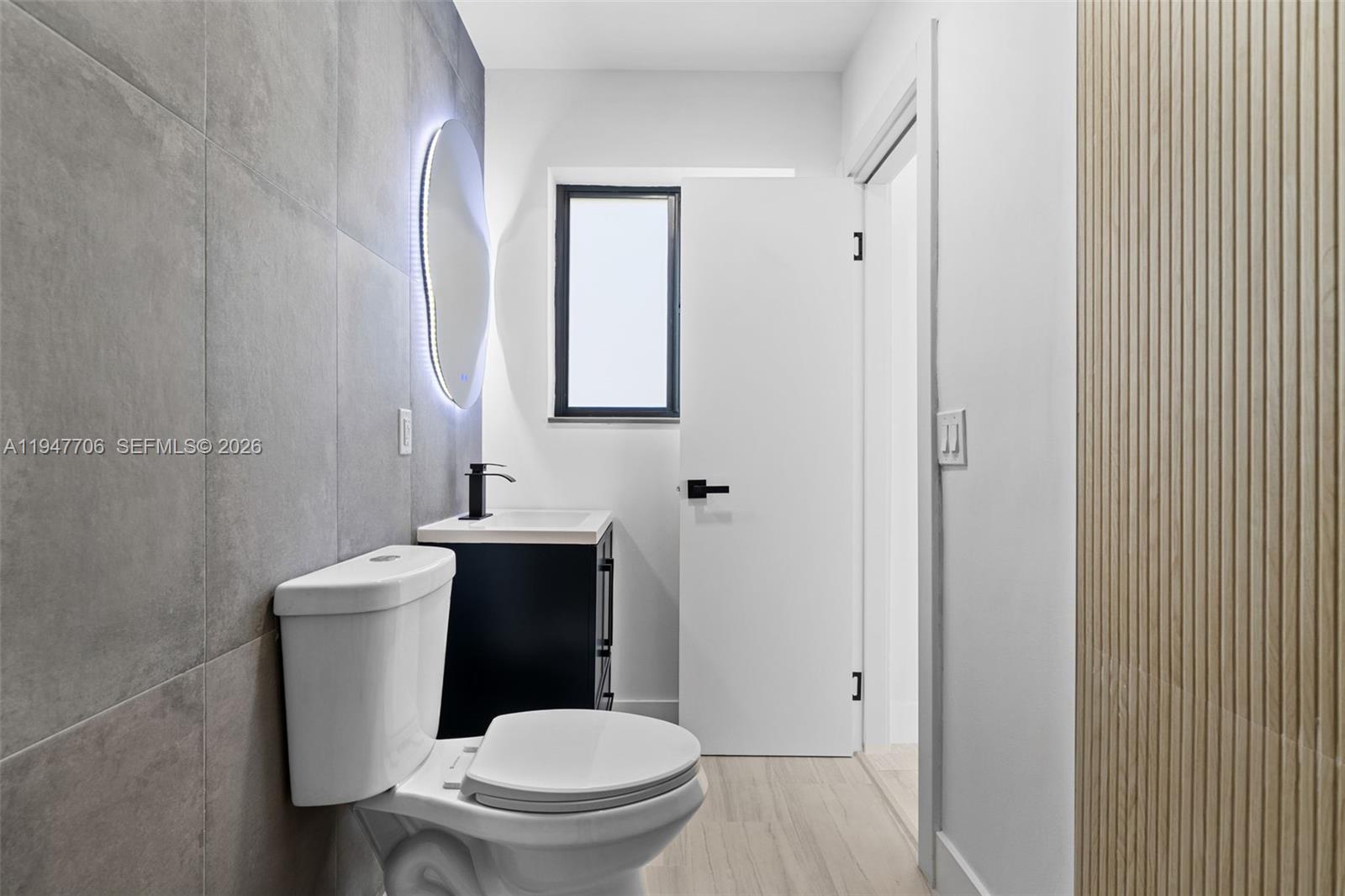 709 Southwest 4th Court Hallandale Beach, FL 33009 - Photo 15 of 59 a white toilet sitting next to a bathroom sink