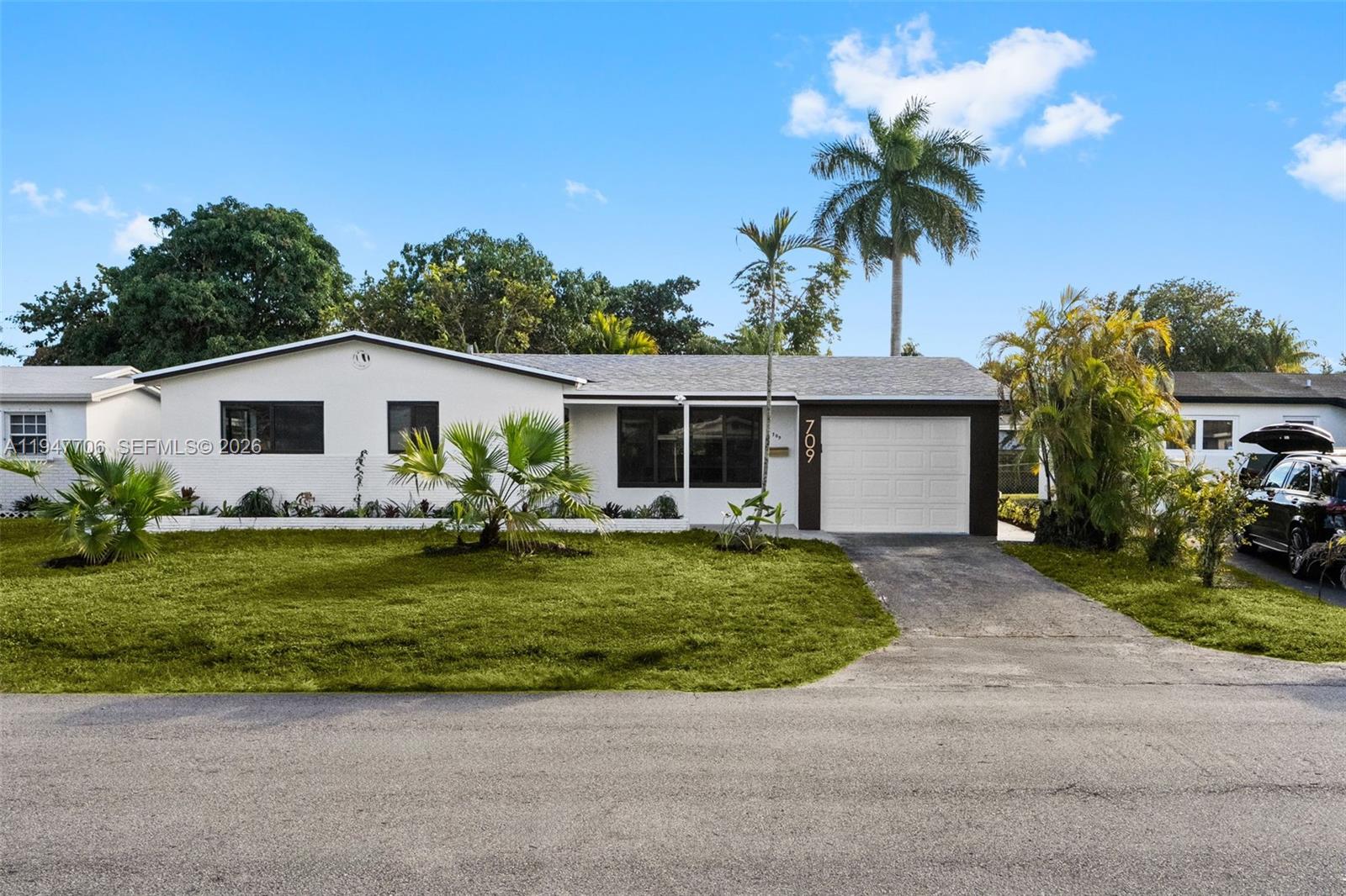 709 Southwest 4th Court Hallandale Beach, FL 33009 - Photo 2 of 59 a front view of house with yard outdoor seating and green space