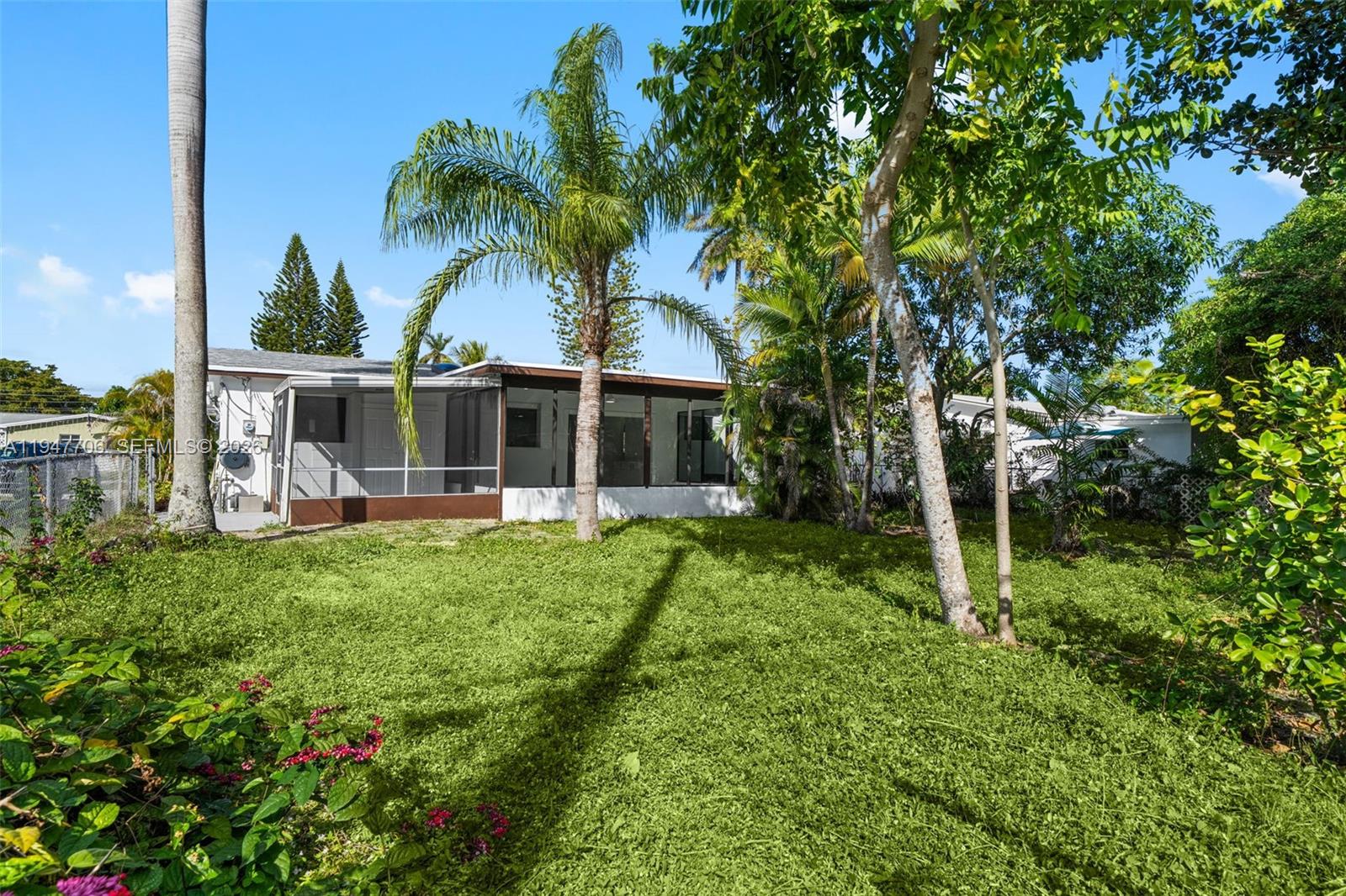 709 Southwest 4th Court Hallandale Beach, FL 33009 - Photo 42 of 59 a view of house with backyard and swimming pool