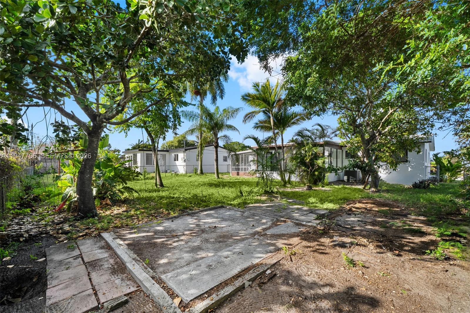 709 Southwest 4th Court Hallandale Beach, FL 33009 - Photo 44 of 59 a view of a yard with plants and large trees
