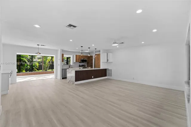 a view of kitchen with kitchen island and stainless steel appliances
